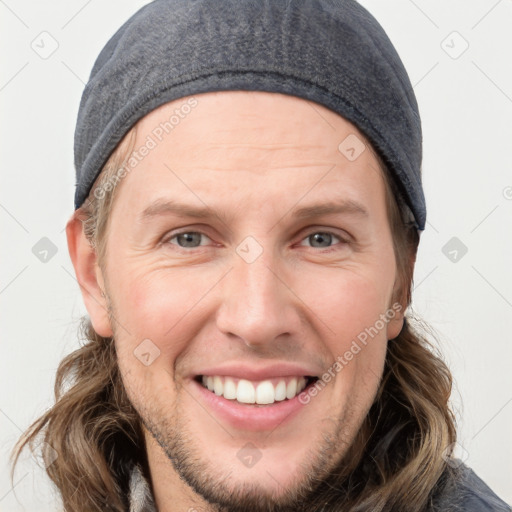 Joyful white adult male with short  brown hair and grey eyes