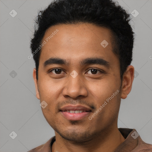 Joyful latino young-adult male with short  black hair and brown eyes