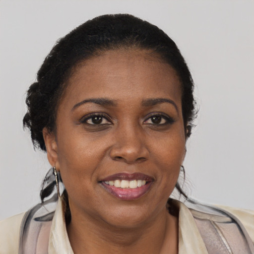Joyful black young-adult female with long  brown hair and brown eyes