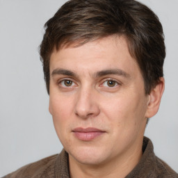 Joyful white adult male with short  brown hair and brown eyes