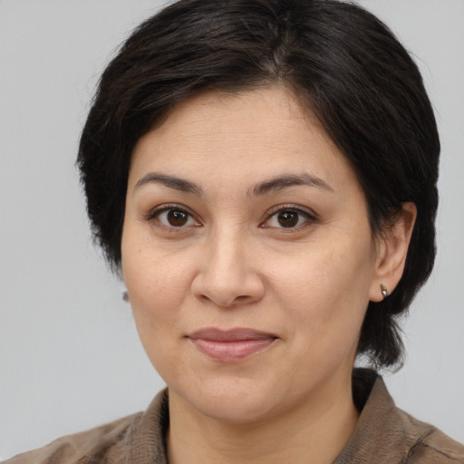Joyful white adult female with medium  brown hair and brown eyes