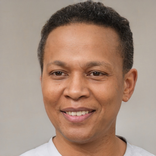 Joyful latino adult male with short  brown hair and brown eyes