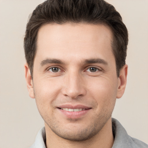 Joyful white young-adult male with short  brown hair and brown eyes