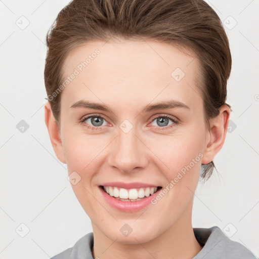 Joyful white young-adult female with short  brown hair and grey eyes