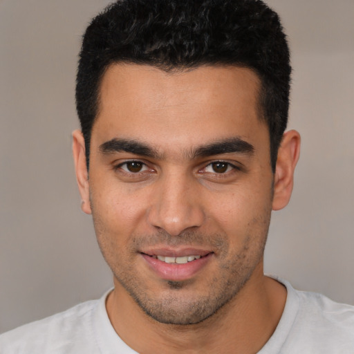 Joyful white young-adult male with short  brown hair and brown eyes