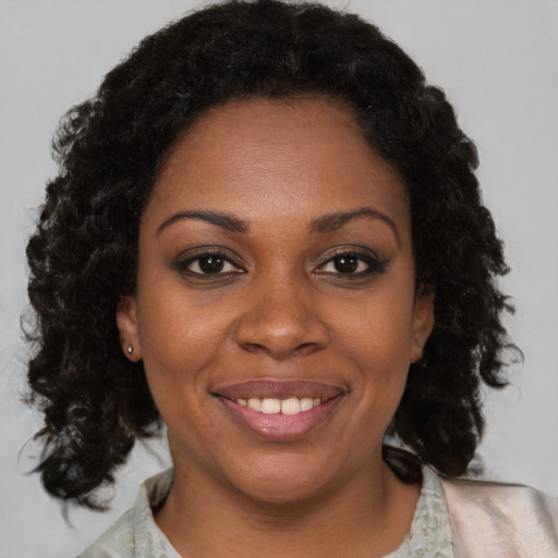 Joyful black young-adult female with medium  black hair and brown eyes