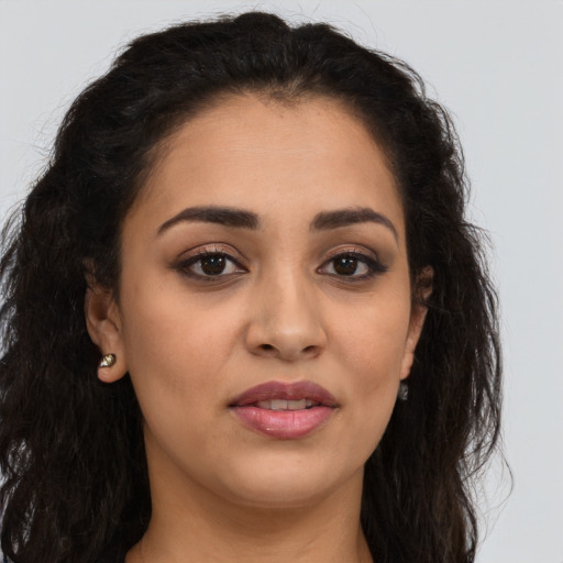 Joyful latino young-adult female with long  brown hair and brown eyes