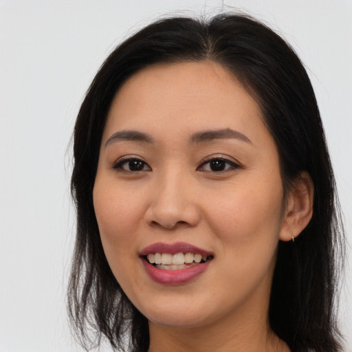 Joyful asian young-adult female with long  brown hair and brown eyes