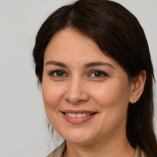 Joyful white adult female with medium  brown hair and brown eyes