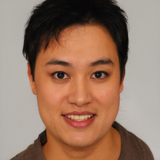 Joyful asian young-adult female with short  brown hair and brown eyes