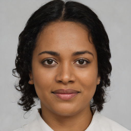 Joyful black young-adult female with medium  brown hair and brown eyes
