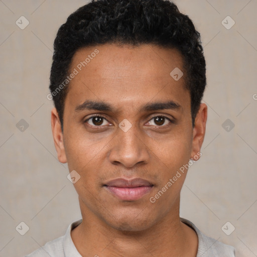 Joyful black young-adult male with short  black hair and brown eyes