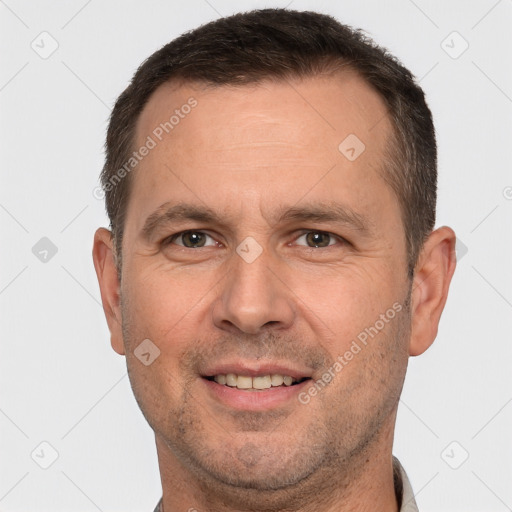 Joyful white adult male with short  brown hair and brown eyes