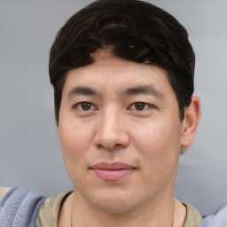 Joyful asian young-adult male with short  brown hair and brown eyes