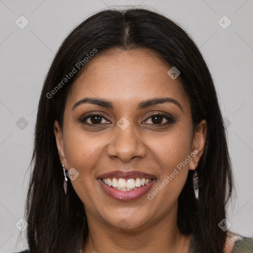 Joyful black young-adult female with long  brown hair and brown eyes