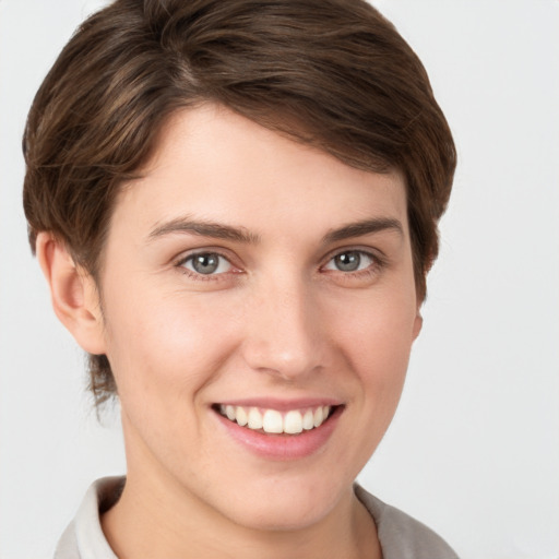 Joyful white young-adult female with short  brown hair and grey eyes