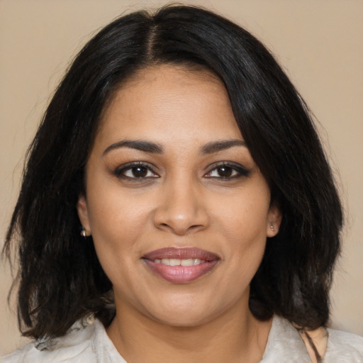 Joyful latino young-adult female with medium  black hair and brown eyes