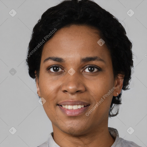 Joyful black young-adult female with short  black hair and brown eyes