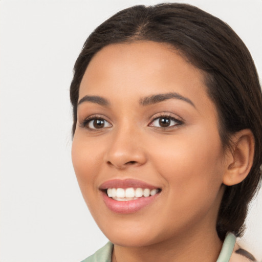 Joyful latino young-adult female with long  brown hair and brown eyes