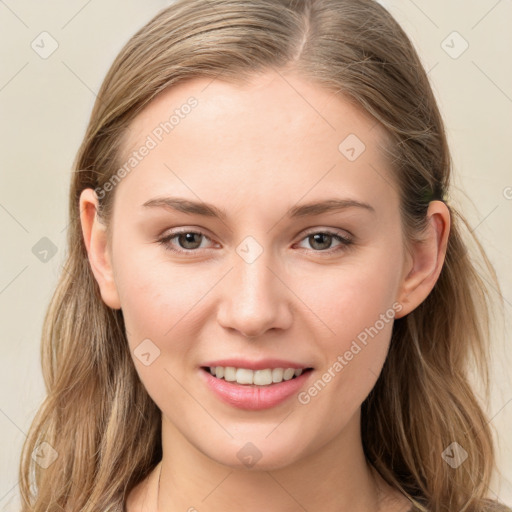 Joyful white young-adult female with long  brown hair and blue eyes