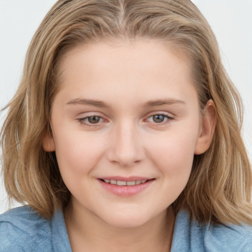 Joyful white child female with medium  brown hair and blue eyes