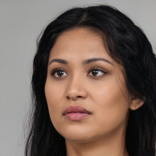 Neutral latino young-adult female with long  black hair and brown eyes