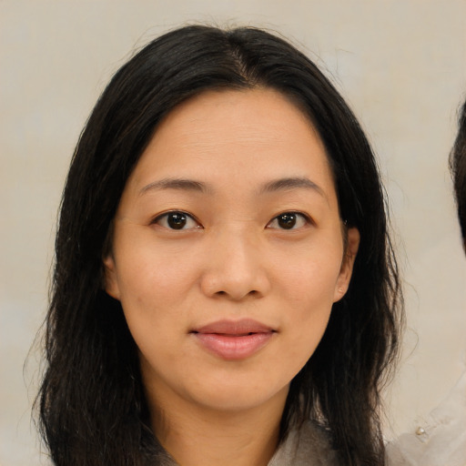 Joyful asian young-adult female with long  brown hair and brown eyes