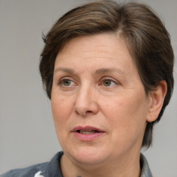 Joyful white middle-aged female with medium  brown hair and grey eyes