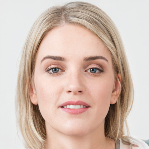 Joyful white young-adult female with medium  brown hair and blue eyes