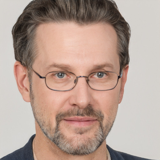 Joyful white adult male with short  brown hair and grey eyes