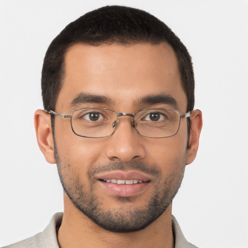 Joyful latino young-adult male with short  black hair and brown eyes