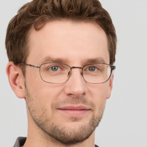 Joyful white adult male with short  brown hair and grey eyes