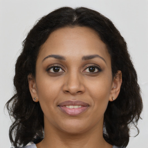 Joyful latino young-adult female with long  brown hair and brown eyes