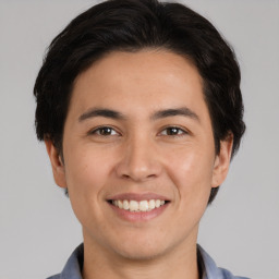 Joyful white young-adult male with medium  brown hair and brown eyes