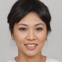 Joyful asian young-adult female with medium  brown hair and brown eyes