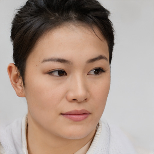 Joyful asian young-adult female with short  brown hair and brown eyes