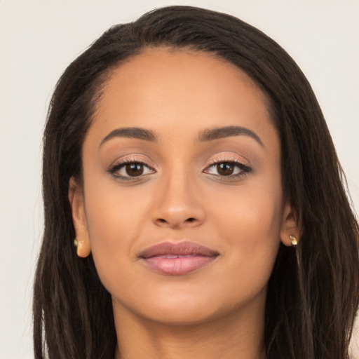 Joyful latino young-adult female with long  brown hair and brown eyes