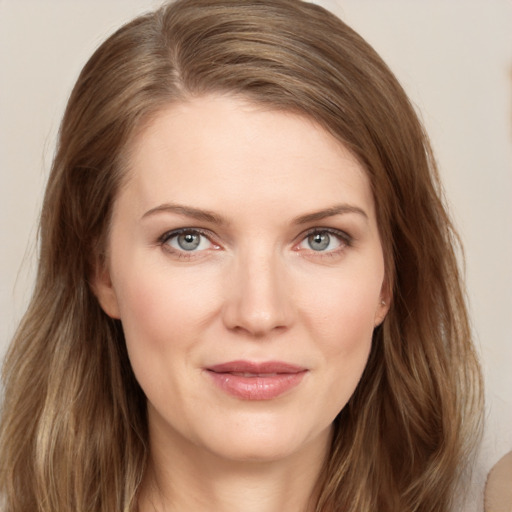 Joyful white young-adult female with long  brown hair and blue eyes