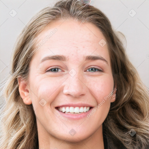 Joyful white young-adult female with long  brown hair and blue eyes