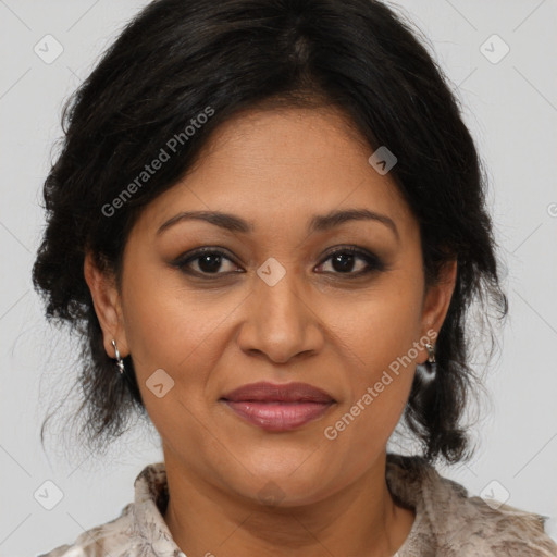 Joyful latino adult female with medium  brown hair and brown eyes