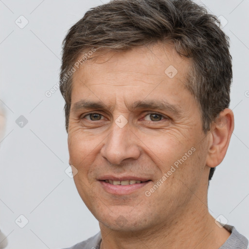 Joyful white adult male with short  brown hair and brown eyes