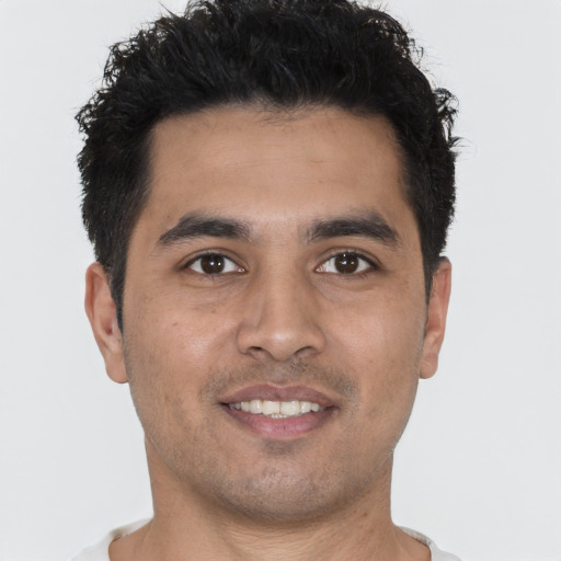 Joyful white young-adult male with short  black hair and brown eyes