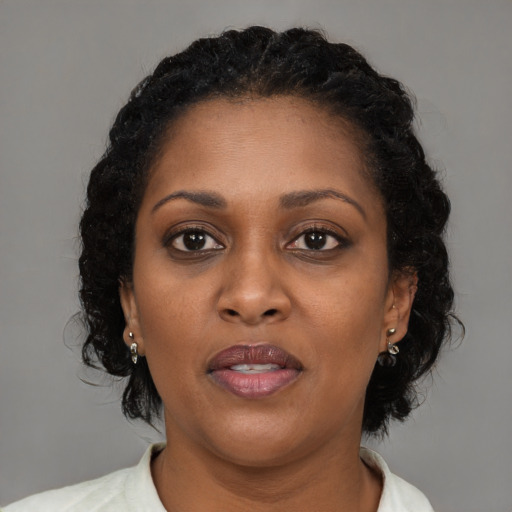 Joyful black young-adult female with medium  brown hair and brown eyes