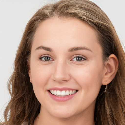 Joyful white young-adult female with long  brown hair and grey eyes