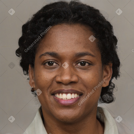 Joyful black adult female with short  black hair and brown eyes