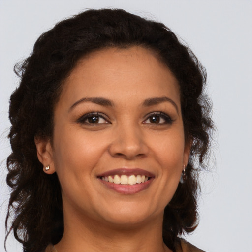 Joyful latino young-adult female with long  brown hair and brown eyes