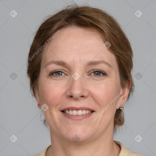 Joyful white adult female with medium  brown hair and grey eyes