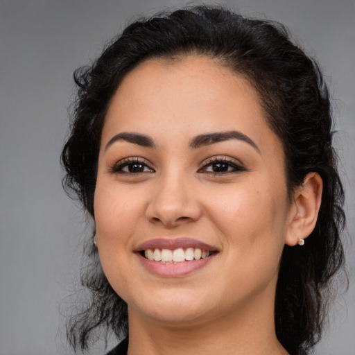 Joyful latino young-adult female with long  brown hair and brown eyes