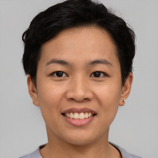 Joyful asian young-adult female with short  black hair and brown eyes