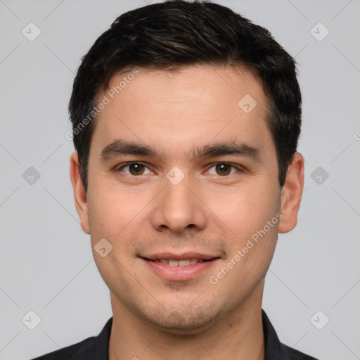 Joyful white young-adult male with short  black hair and brown eyes